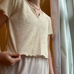 cream colored light weight t shirt with v neckline